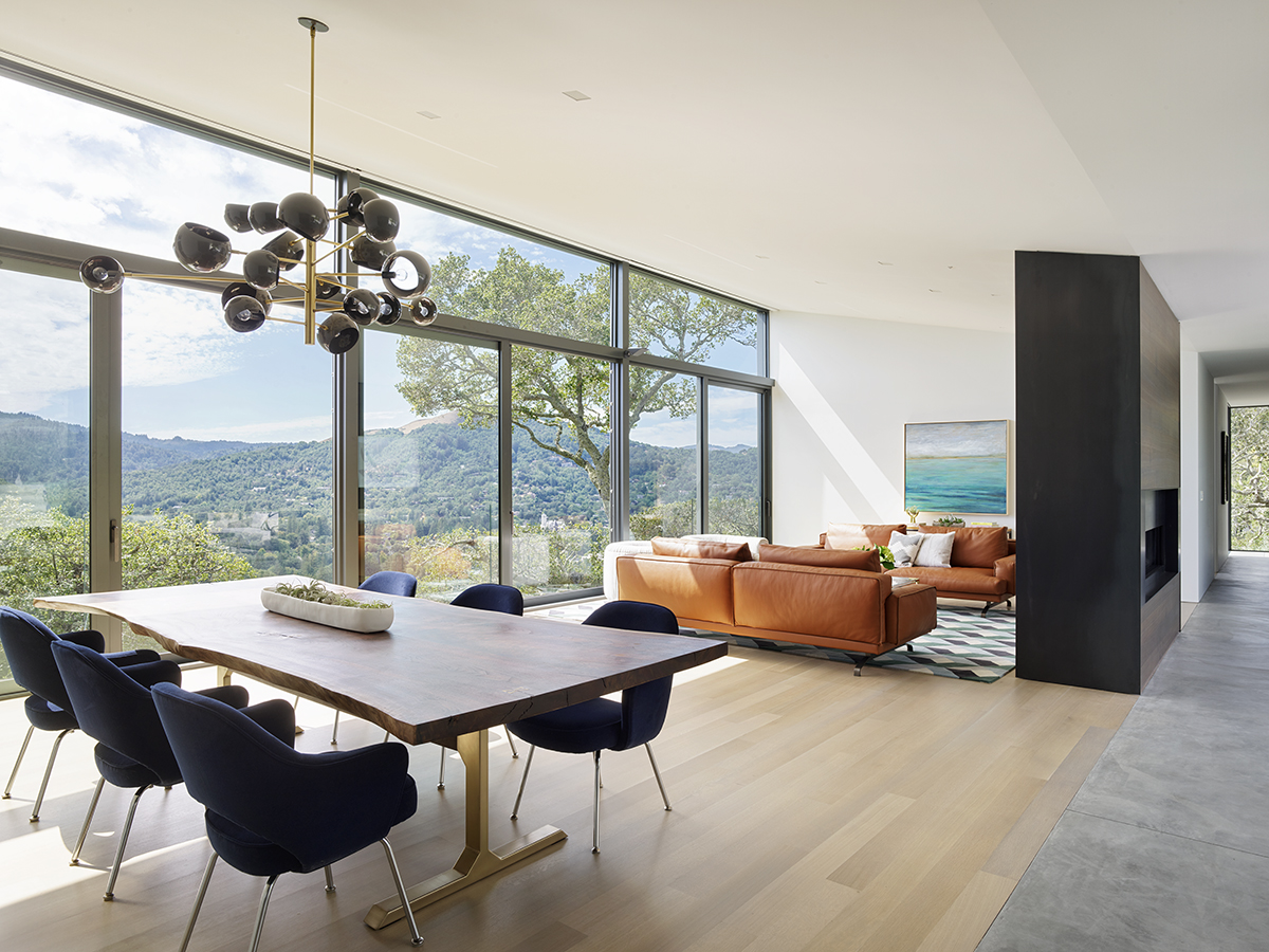 Ross Hillside modern home inside view of living area with couches, table and chairs